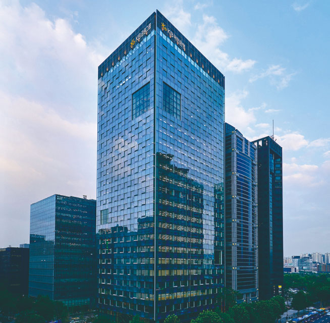 A picture of KB Financial Group building looking up from below so that you can see the sky